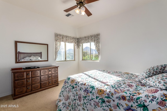 bedroom with ceiling fan and light carpet