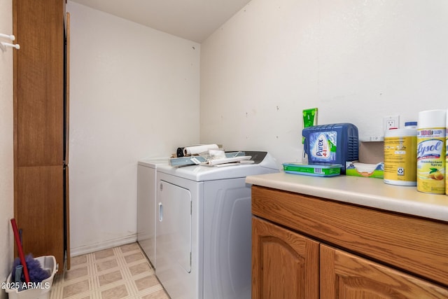 washroom featuring cabinets and independent washer and dryer