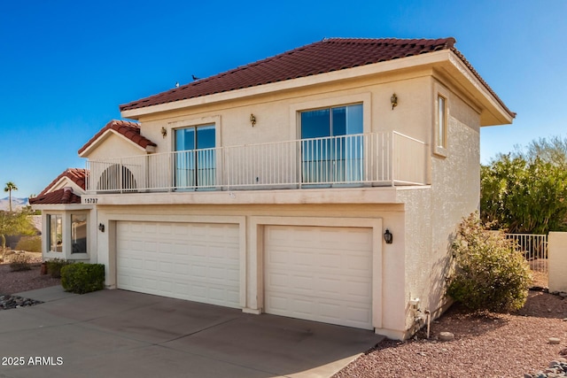 view of front of home with a balcony and a garage