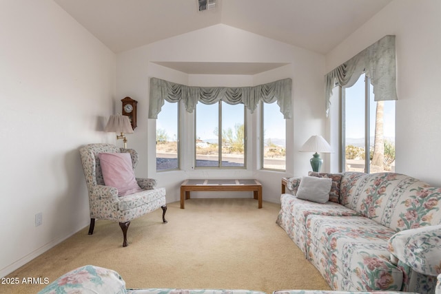 living area with carpet flooring and vaulted ceiling