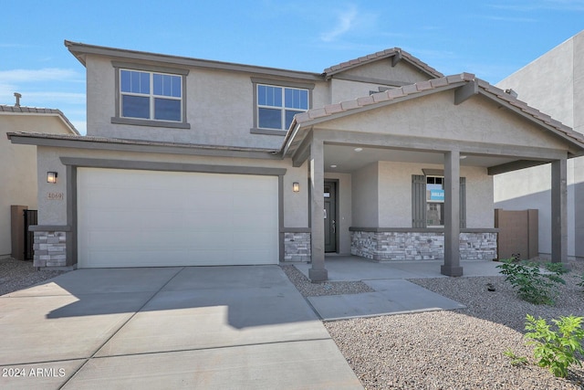 view of front of house with a porch and a garage