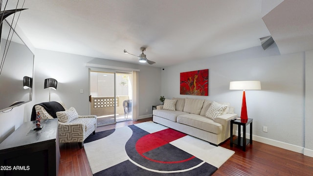 living room featuring baseboards, dark wood finished floors, and a ceiling fan