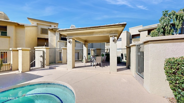 back of house with a patio area, fence, and stucco siding