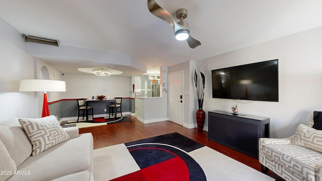 living area with baseboards and wood finished floors