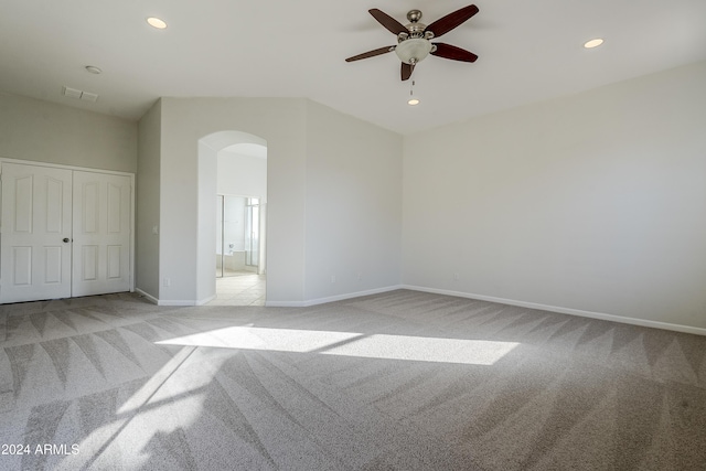 carpeted spare room with ceiling fan