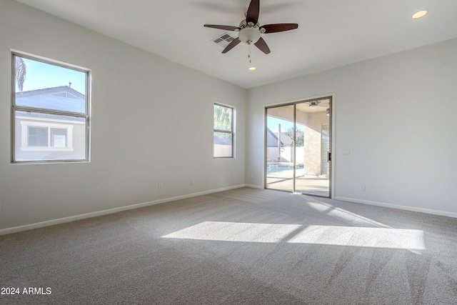 unfurnished room featuring ceiling fan and carpet floors