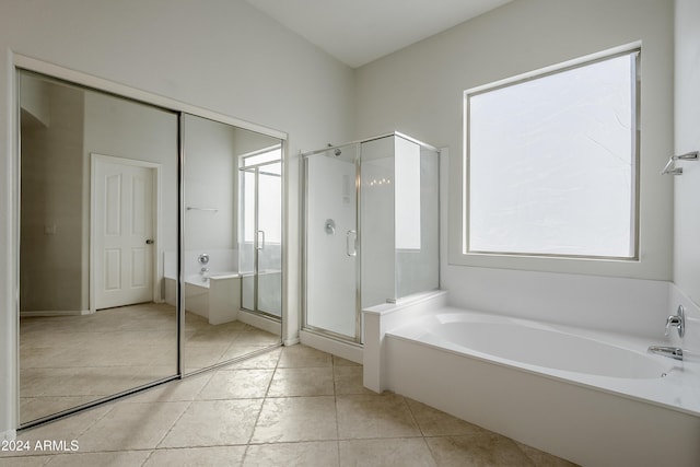 bathroom featuring tile patterned floors and independent shower and bath