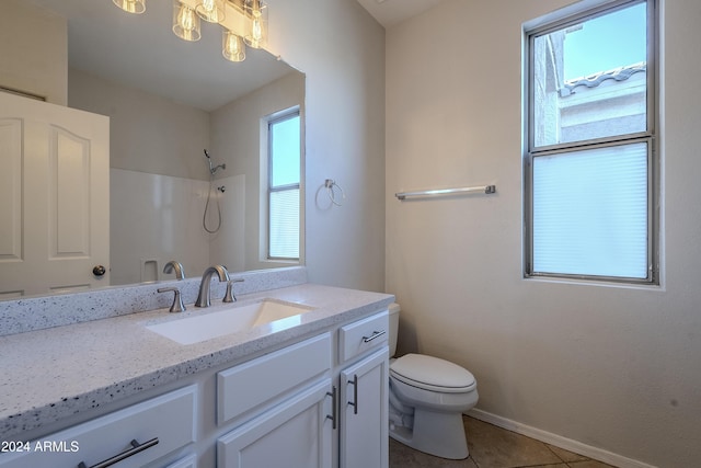 bathroom with tile patterned flooring, a shower, vanity, and toilet