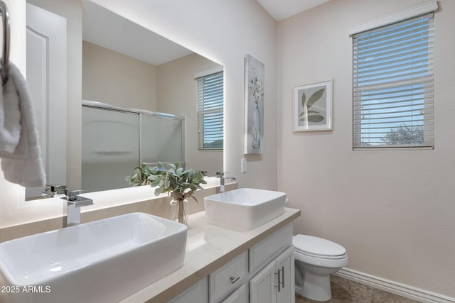 bathroom featuring walk in shower, vanity, toilet, and plenty of natural light