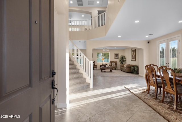 entrance foyer with a towering ceiling and french doors