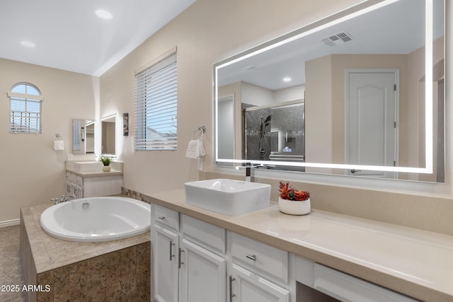 bathroom with vanity and plus walk in shower