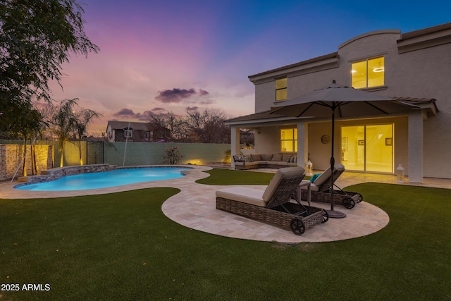 pool at dusk featuring pool water feature, an outdoor living space, a patio area, and a lawn