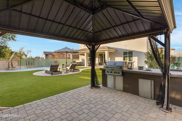 view of patio / terrace featuring a grill, a gazebo, sink, and exterior kitchen