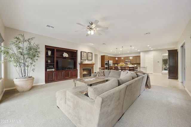 2727 S Balboa Dr, Gilbert, AZ 85295 - living area featuring ceiling fan, light colored carpet, a warm lit fireplace, baseboards, and recessed lighting