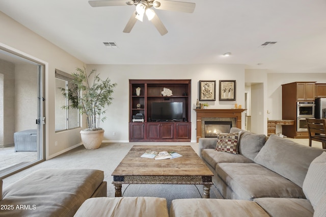 2727 S Balboa Dr, Gilbert, AZ 85295 - living room with a ceiling fan, light colored carpet, baseboards, and a glass covered fireplace