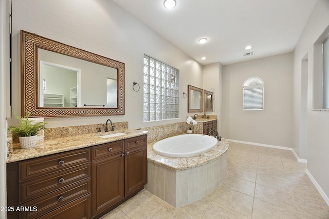 2727 S Balboa Dr, Gilbert, AZ 85295 - full bath with a garden tub, two vanities, tile patterned flooring, baseboards, and recessed lighting
