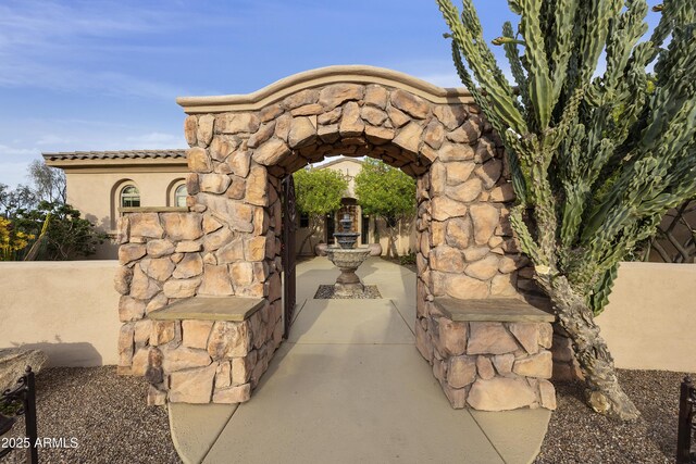 2727 S Balboa Dr, Gilbert, AZ 85295 - doorway to property featuring stucco siding, a tiled roof, and stone siding