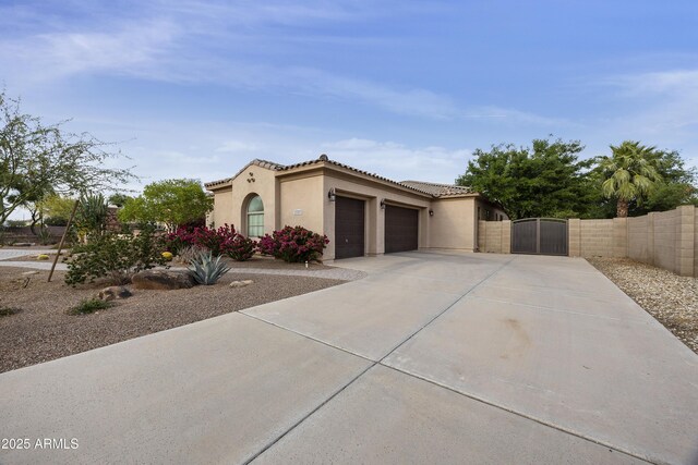 2727 S Balboa Dr, Gilbert, AZ 85295 - mediterranean / spanish home featuring a gate, a garage, concrete driveway, stucco siding, and fence