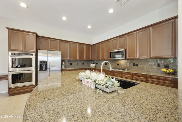 2727 S Balboa Dr, Gilbert, AZ 85295 - kitchen featuring stainless steel appliances, light stone countertops, tasteful backsplash, recessed lighting, and a sink