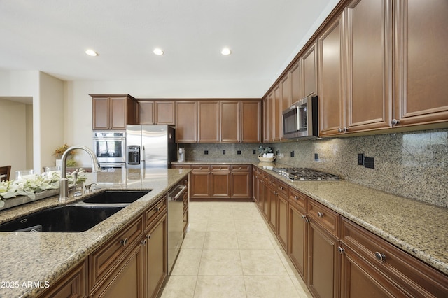 2727 S Balboa Dr, Gilbert, AZ 85295 - kitchen featuring appliances with stainless steel finishes, a sink, light stone counters, tasteful backsplash, and recessed lighting