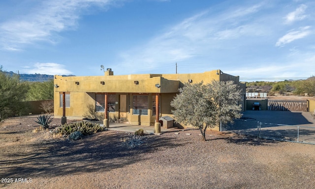 back of house featuring a patio area, fence, and stucco siding