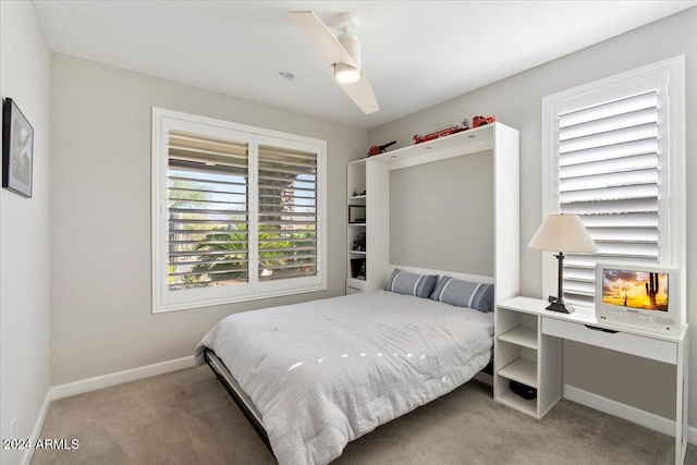 bedroom featuring ceiling fan and carpet