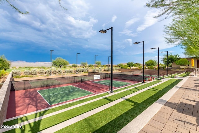 view of home's community featuring tennis court