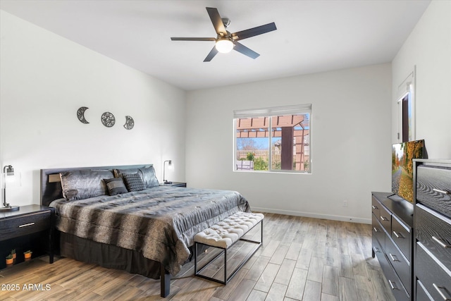 bedroom with ceiling fan, light wood-type flooring, and baseboards