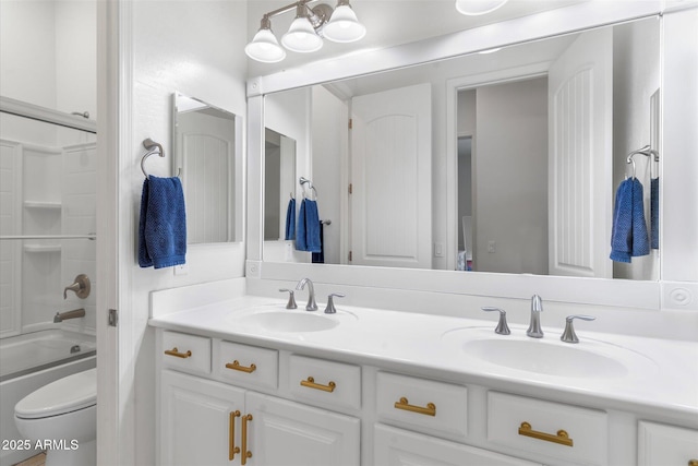 full bathroom featuring double vanity, toilet, a sink, and shower / bathtub combination