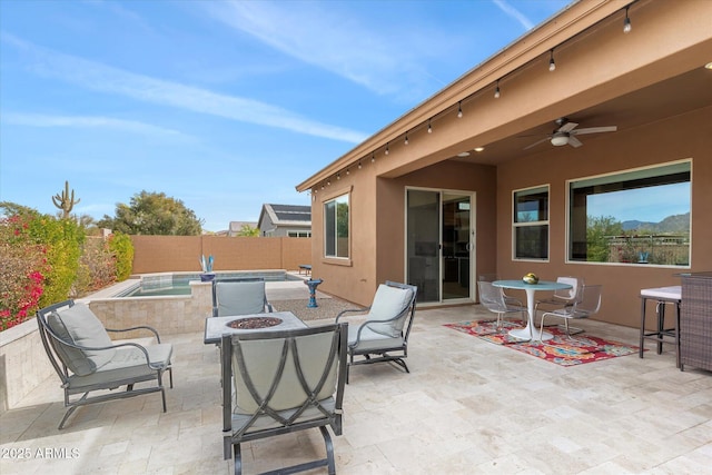 view of patio featuring ceiling fan, an outdoor fire pit, a fenced backyard, and a fenced in pool