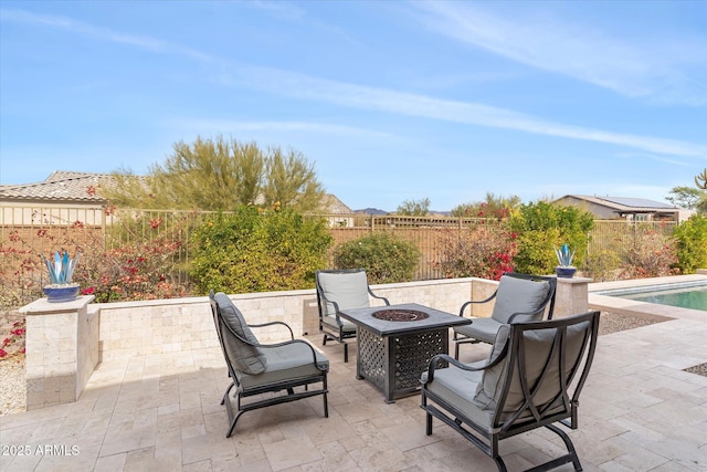 view of patio with a fenced in pool, an outdoor fire pit, and a fenced backyard