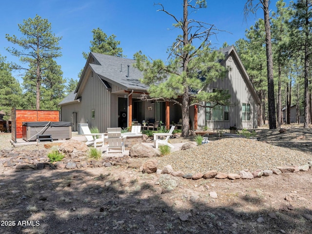 956 S Torrey Pines Dr, Williams, AZ 86046 - back of house with a hot tub, a patio, a shingled roof, and board and batten siding