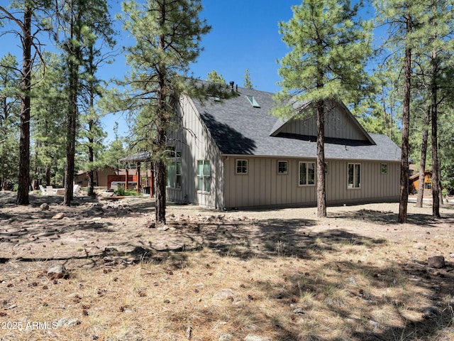 956 S Torrey Pines Dr, Williams, AZ 86046 - back of property featuring roof with shingles and board and batten siding
