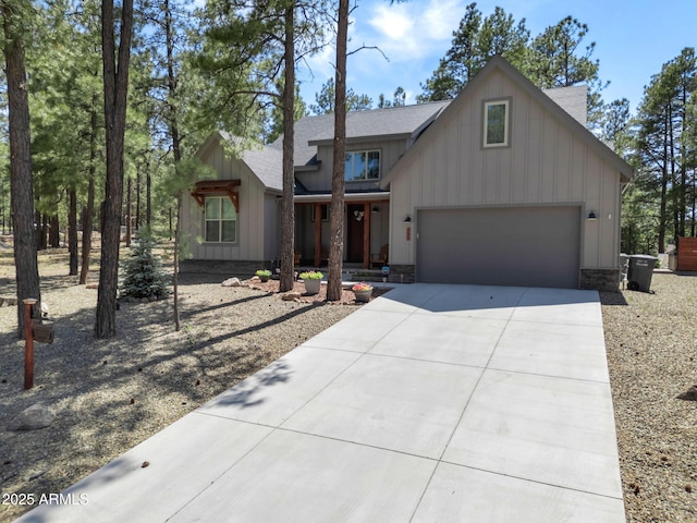 956 S Torrey Pines Dr, Williams, AZ 86046 - view of front of house with driveway, board and batten siding, and roof with shingles