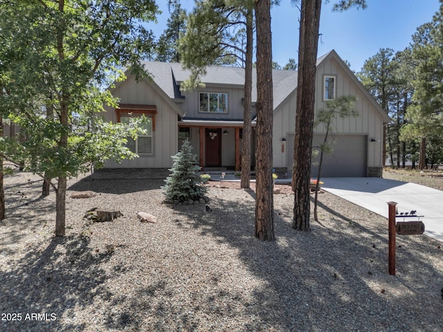 956 S Torrey Pines Dr, Williams, AZ 86046 - view of front facade featuring concrete driveway, an attached garage, board and batten siding, and a shingled roof