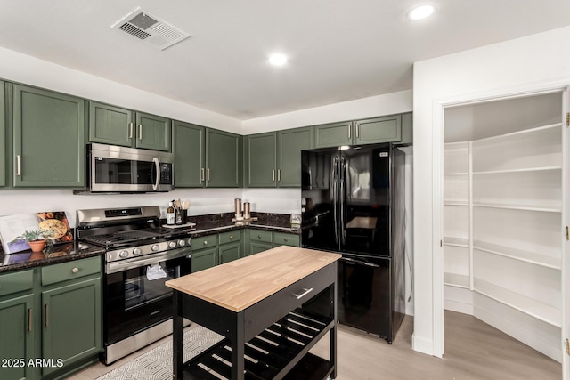 kitchen with visible vents, recessed lighting, stainless steel appliances, light wood-style floors, and green cabinets