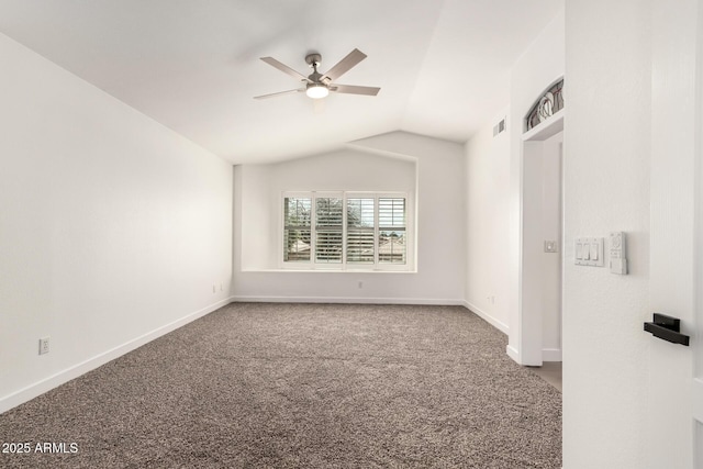 unfurnished room with lofted ceiling, carpet flooring, a ceiling fan, and baseboards