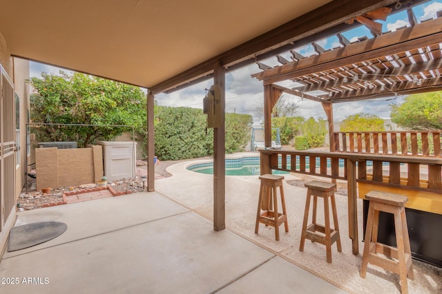 view of patio / terrace with an outdoor pool, fence, and a pergola