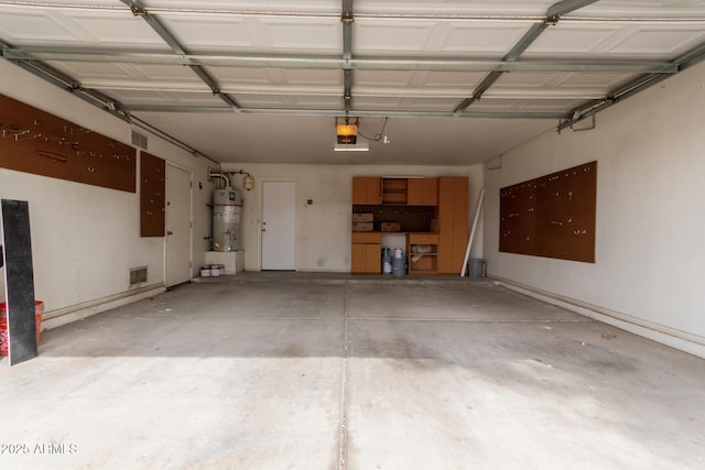 garage with visible vents, gas water heater, and a garage door opener