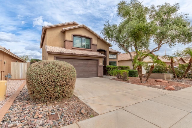 view of front of home with stucco siding, an attached garage, driveway, and a tile roof