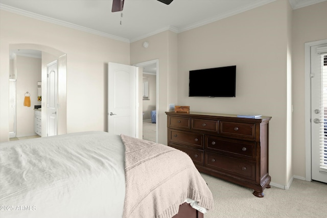 bedroom featuring ceiling fan, light carpet, ornamental molding, and ensuite bath