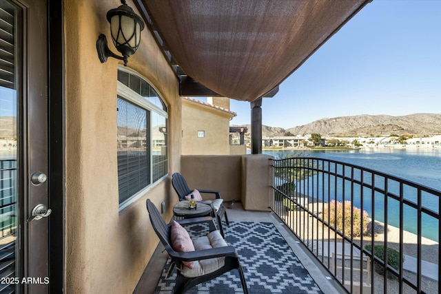 balcony with a water and mountain view