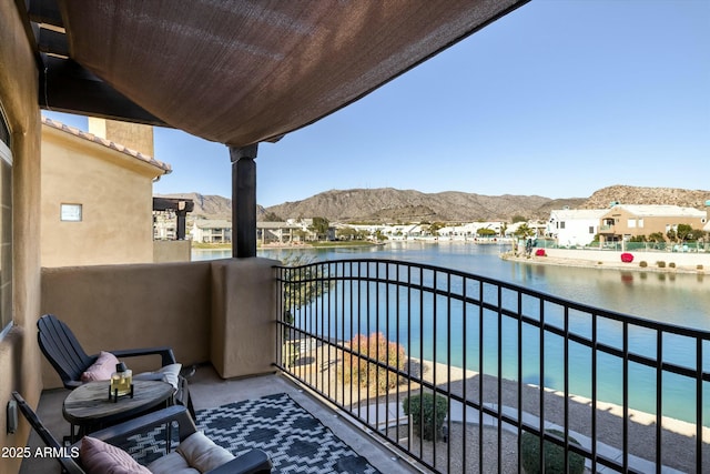 balcony with a water and mountain view