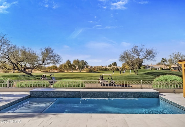 view of swimming pool featuring pool water feature and a lawn