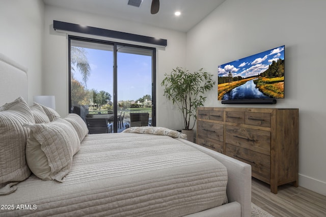 bedroom featuring hardwood / wood-style flooring and access to exterior