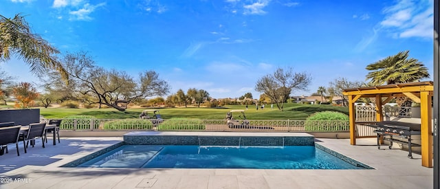 view of swimming pool with pool water feature, a grill, a jacuzzi, and a patio area