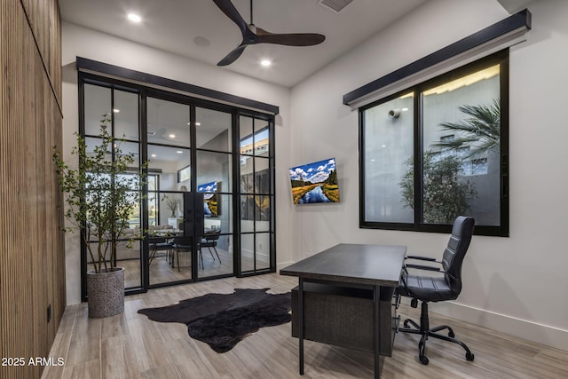 office with french doors, ceiling fan, and light hardwood / wood-style floors