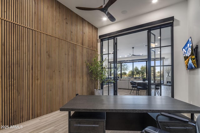 interior space with light wood-type flooring and ceiling fan