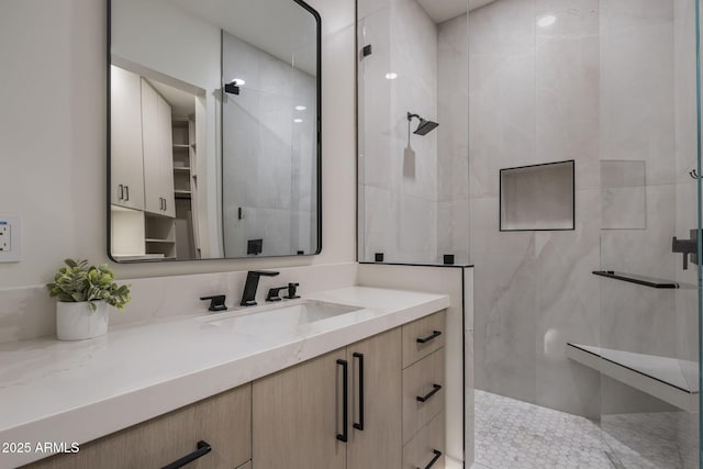 bathroom with vanity and tiled shower