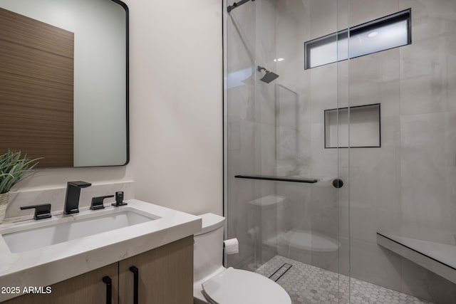 bathroom with vanity, toilet, and a shower with shower door